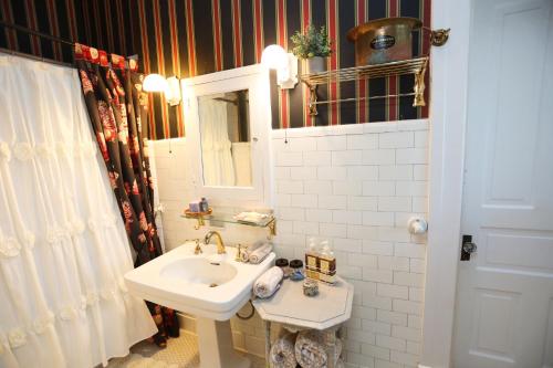 a white bathroom with a sink and a mirror at Virginia Point INN in Galveston