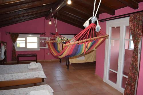 a room with a hammock hanging from the ceiling at Private Villa AKOBARA, 2km from city center in Corfu Town