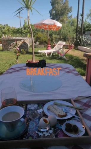 a table with a break fast sign and food on it at Private Villa AKOBARA, 2km from city center in Corfu Town