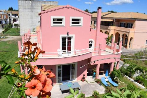 a pink house with flowers in front of it at Private Villa AKOBARA, 2km from city center in Corfu Town
