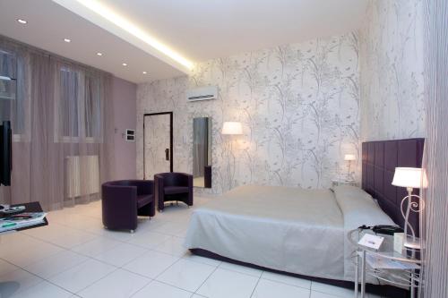 a bedroom with a bed and a table and chairs at Hotel Centrale in Bologna