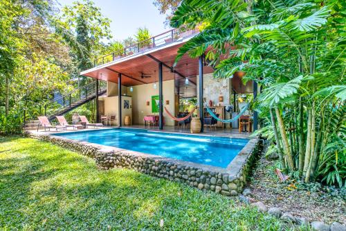a house with a swimming pool with a swing at Villas Piña - Adults only in Puerto Viejo