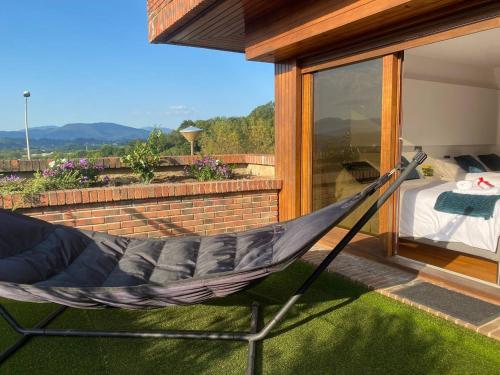 a hammock on a balcony of a house at Ondarreta Beach - Singular y exclusivo in Donostia-San Sebastián