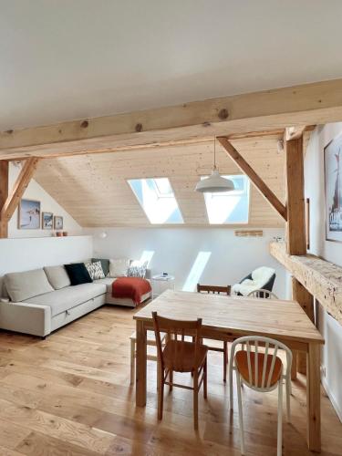 a living room with a table and a couch at Triplex In The Heart Of Chamonix in Chamonix-Mont-Blanc