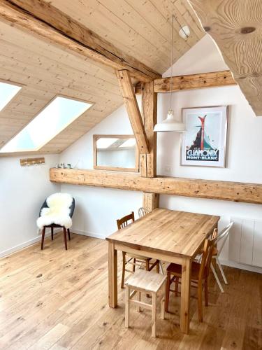 a dining room with a wooden table and chairs at Triplex In The Heart Of Chamonix in Chamonix-Mont-Blanc