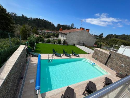 a swimming pool in the backyard of a house at Fonte Retreat - Holiday Home in Sandim