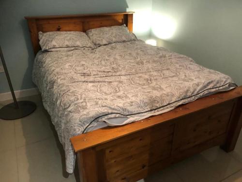 a bed in a bedroom with a wooden bed frame at The Little Hexthorpe house in Doncaster