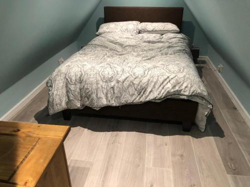 a bed in a bedroom with a wooden floor at The Little Hexthorpe house in Doncaster