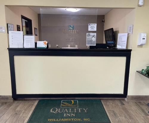 a large display screen in a waiting room at Quality Inn Williamston in Williamston