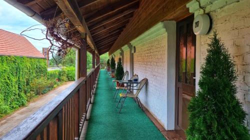 a porch with chairs and a table on it at Landhaus Kyritz in Kyritz