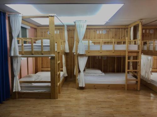 a room with four bunk beds in it at Jo Eun Jip Guesthouse in Mokpo