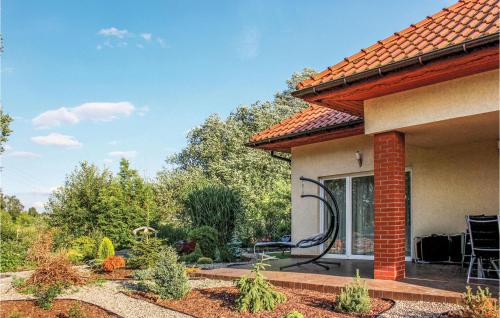 a house with a large window with a garden at Awesome Home In Kobylanka With Wifi in Kobylanka