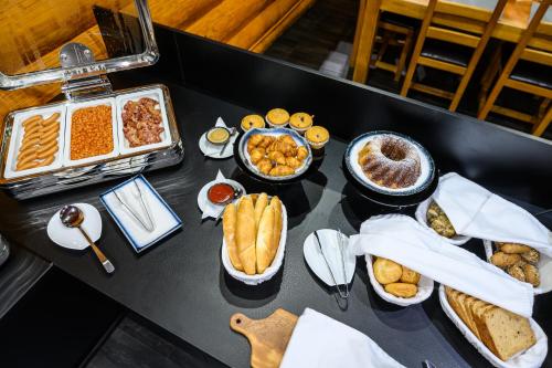a table filled with different types of food on a table at Hotel ZEMPLEN in Michalovce