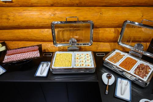 a table with several trays of food on it at Hotel ZEMPLEN in Michalovce