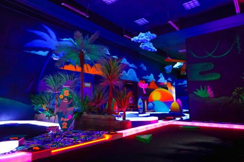 a room with potted plants and neon lights at Castaway Bay by Cedar Point Resorts in Sandusky