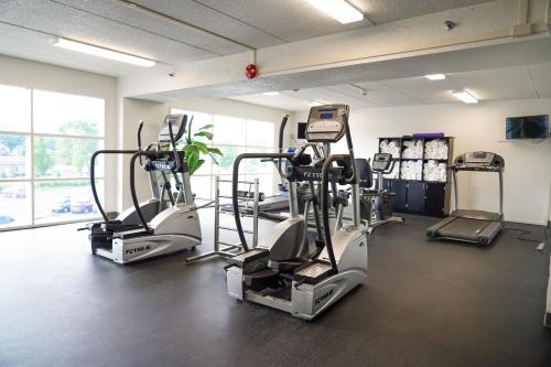 a gym with treadmills and ellipticals in a room at Castaway Bay by Cedar Point Resorts in Sandusky