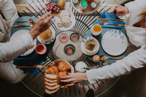 a group of people sitting at a table with food at Villa Geva in Montignies-le-Tilleul