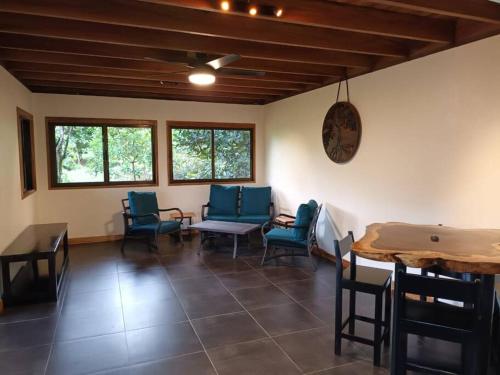 a dining room with blue chairs and a table at Cascadas Corcovado - luxury villa in Charcos