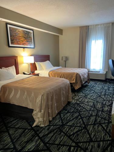 a hotel room with two beds and a window at Quality Inn Lake City in Lake City