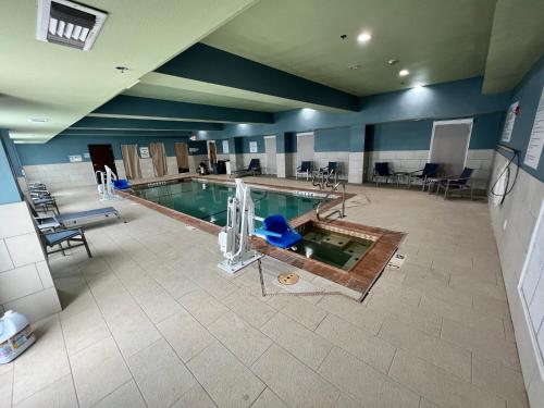 an overhead view of a swimming pool in a building at Holiday Inn Express & Suites Corpus Christi by IHG in Corpus Christi