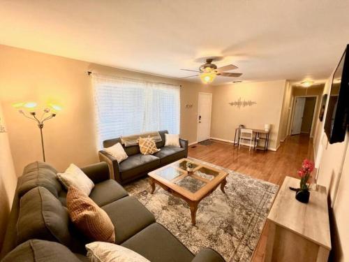 a living room with a couch and a table at *Comfortable Townhome * King Beds * Long Term* in Cary