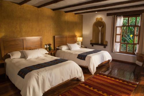 Postel nebo postele na pokoji v ubytování Guayaba Inn Boutique Hotel