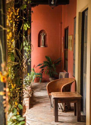 a hallway with a table and chairs in a building at Guayaba Inn Boutique Hotel in San Cristóbal de Las Casas