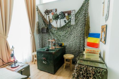 a room with a green chest and a table at Catharsis House - self check in and self checkout in Oradea
