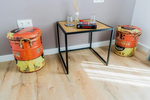 a table and two drums in a room at Catharsis House - self check in and self checkout in Oradea