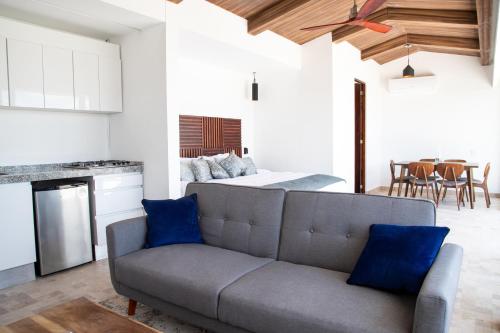 a living room with a couch and a bed at Kiin Tulum, Luxury Suites in Tulum