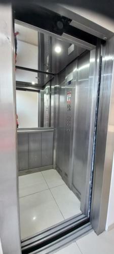 an empty refrigerator with a glass door in a room at Departamento126 in Junín