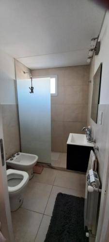 a bathroom with a toilet and a sink at Departamento126 in Junín
