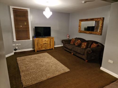 a living room with a couch and a flat screen tv at Blackpool Home with Tower View in Blackpool