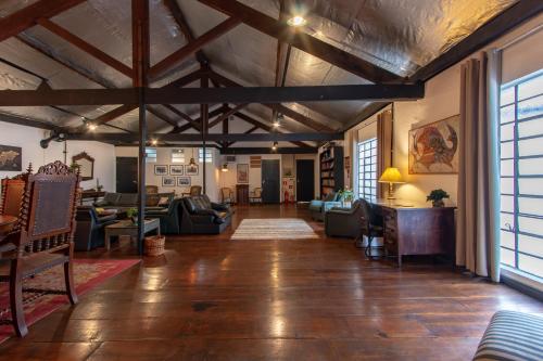 a large living room with wooden floors and a large window at BH Studios Hotel Brás in Sao Paulo