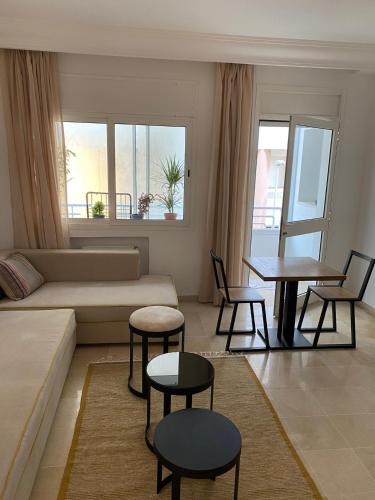 a living room with a couch and a table and chairs at Cosy Flat Lac 1, Tunis in Tunis