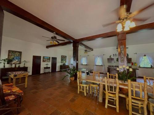 a large living room with a table and chairs at Hacienda La Esperanza in Copán Ruinas