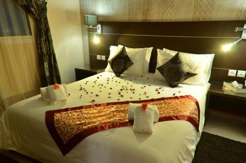 a hotel room with a bed with confetti on it at Hotel Al Akha in Sidi Harazem