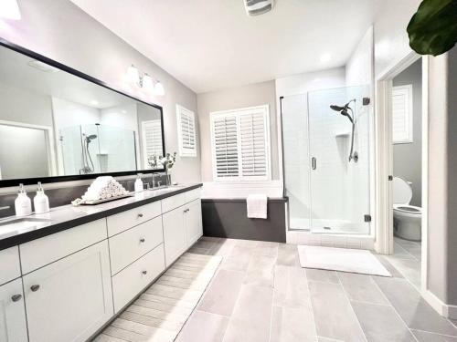 a white bathroom with a sink and a shower at San Diego Luxury Oasis in Spring Valley
