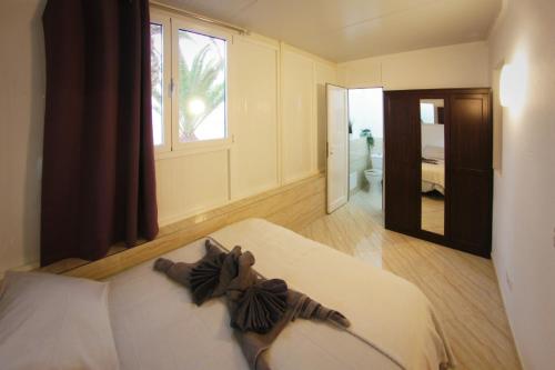 a bedroom with a bed and a window and a bathroom at Apartamento Playa Blanca in Playa Blanca