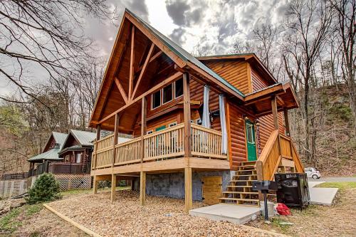 a large wooden cabin with a staircase in front of a house at River Elegance #2335 in Pigeon Forge