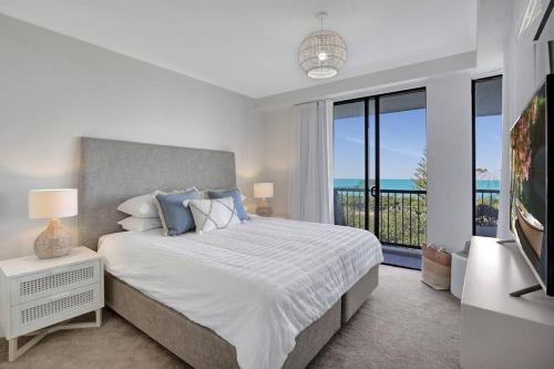 a bedroom with a large bed and a large window at Panoramic Ocean View 2 bed 2 bath in Alexandra Headland