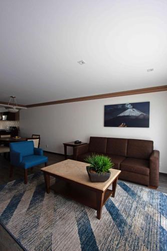 a living room with a couch and a coffee table at Suites Obelisk in Mexico City