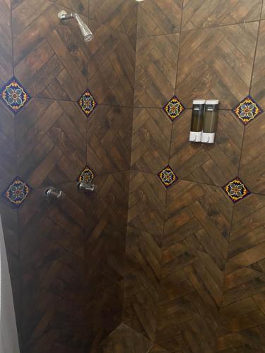 a bathroom with a shower with wooden floors at Estancita Elena in Valle de Guadalupe