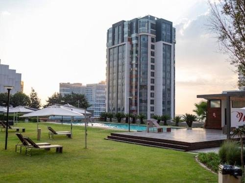 a park with benches and a building in the background at Nal'enzo Luxe Stays in Johannesburg