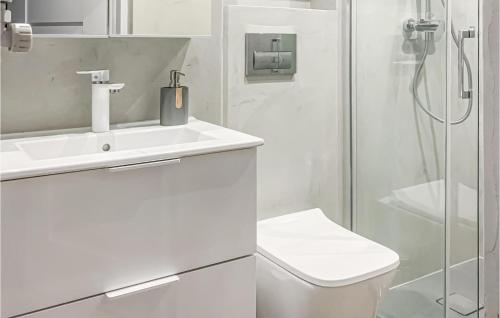 a white bathroom with a sink and a shower at Nice Home In Kielno With Wifi in Kielno