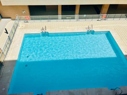 an overhead view of a large blue swimming pool at Luxury Pacifico Beach in Málaga