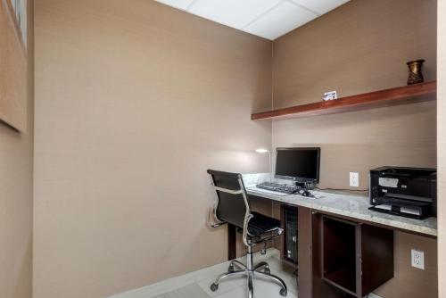 an office with a desk with a computer and a chair at Best Western Plus Red Deer Inn & Suite in Red Deer