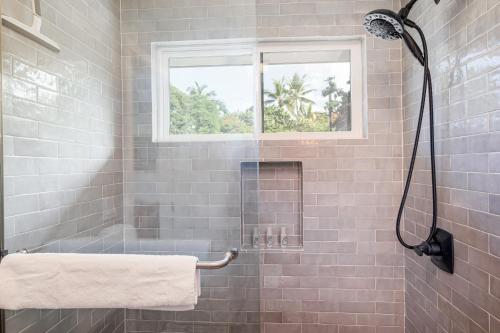 a bathroom with a shower with a window at The Shack in Kailua-Kona