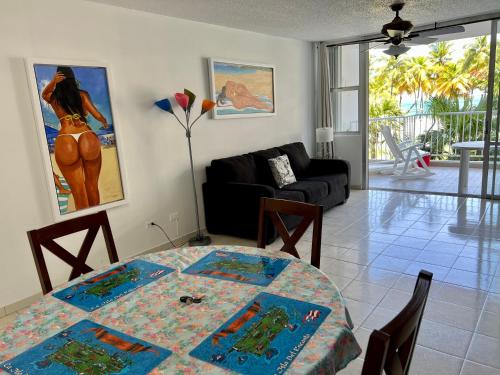 a living room with a table and a couch at Beachfront Tropical Tantra Apartment in San Juan