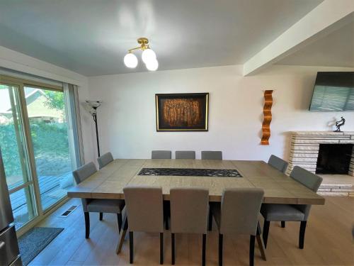 a dining room with a table and chairs and a fireplace at Modern 7-bedroom Home Near Downtown SLC in Millcreek